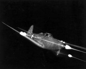 Bell_P-39_Airacobra_in_flight_firing_all_weapons_at_night
